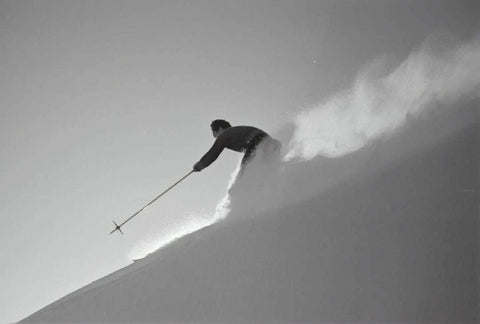 Professional skier descending snowy slope, highlighting importance of micronutrients in sports nutrition for energy and recovery