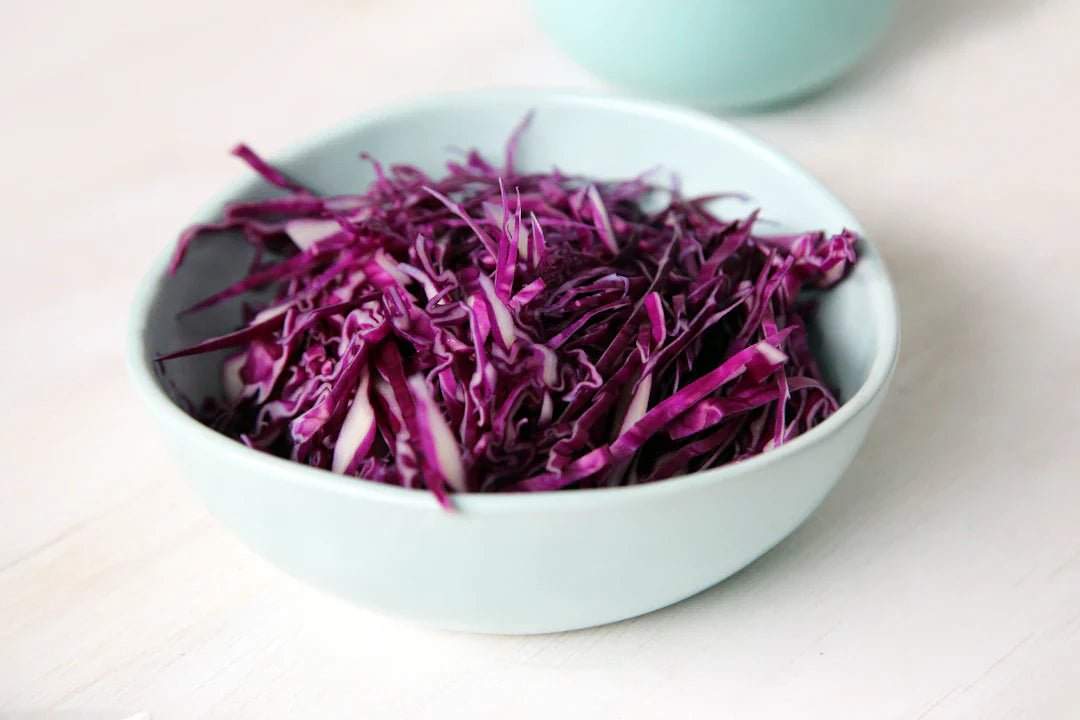 Bowl of fresh shredded red cabbage as a healthy pre-workout nutrition option.