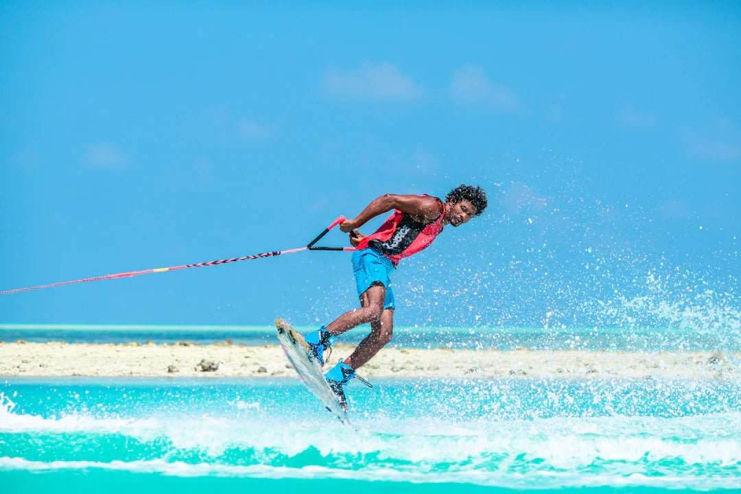 Athlete waterskiing on clear blue ocean under sunny sky illustrating hydration in sport for peak performance.