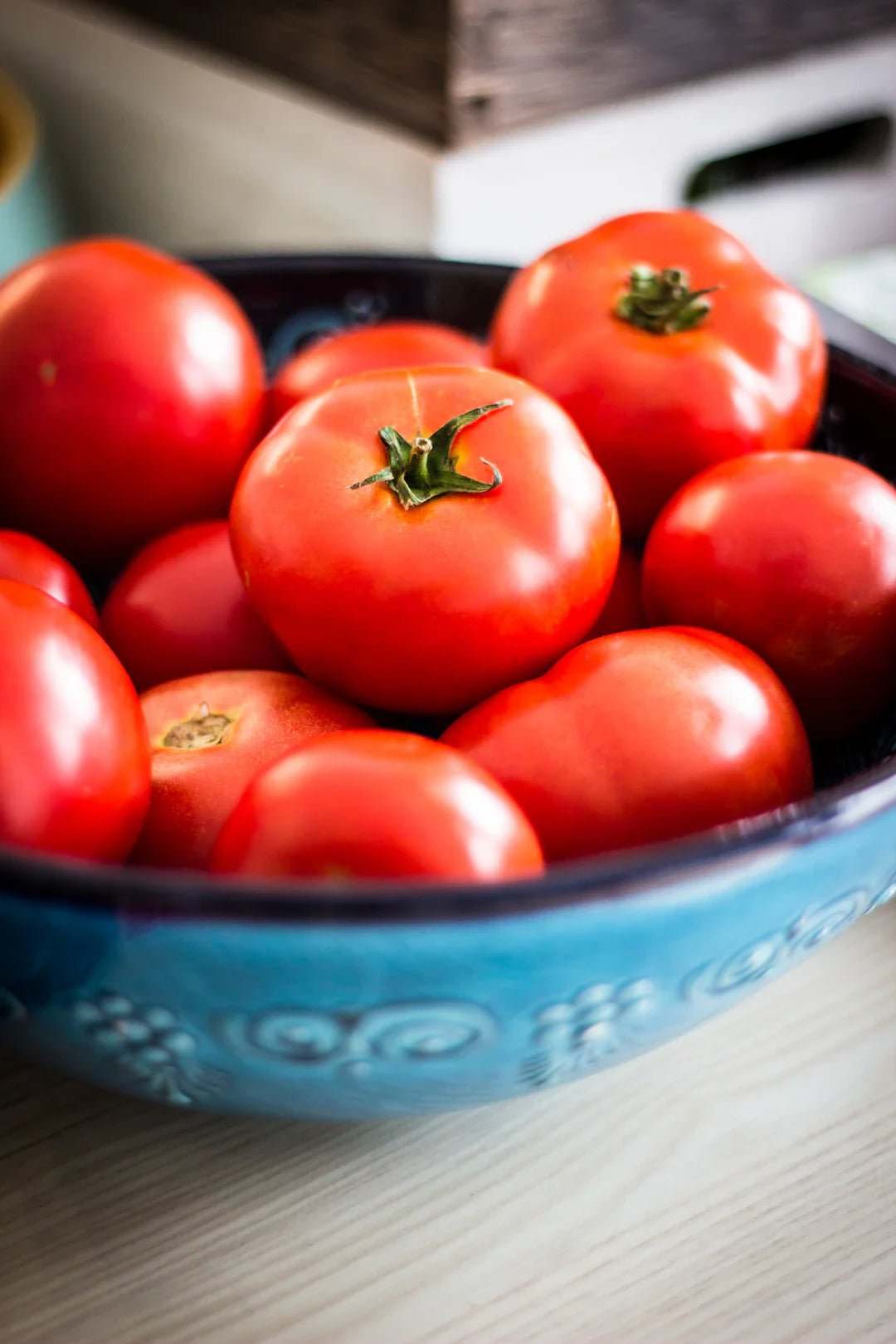 Fresh red tomatoes in a blue bowl emphasizing that sports nutrition is not just for professionals